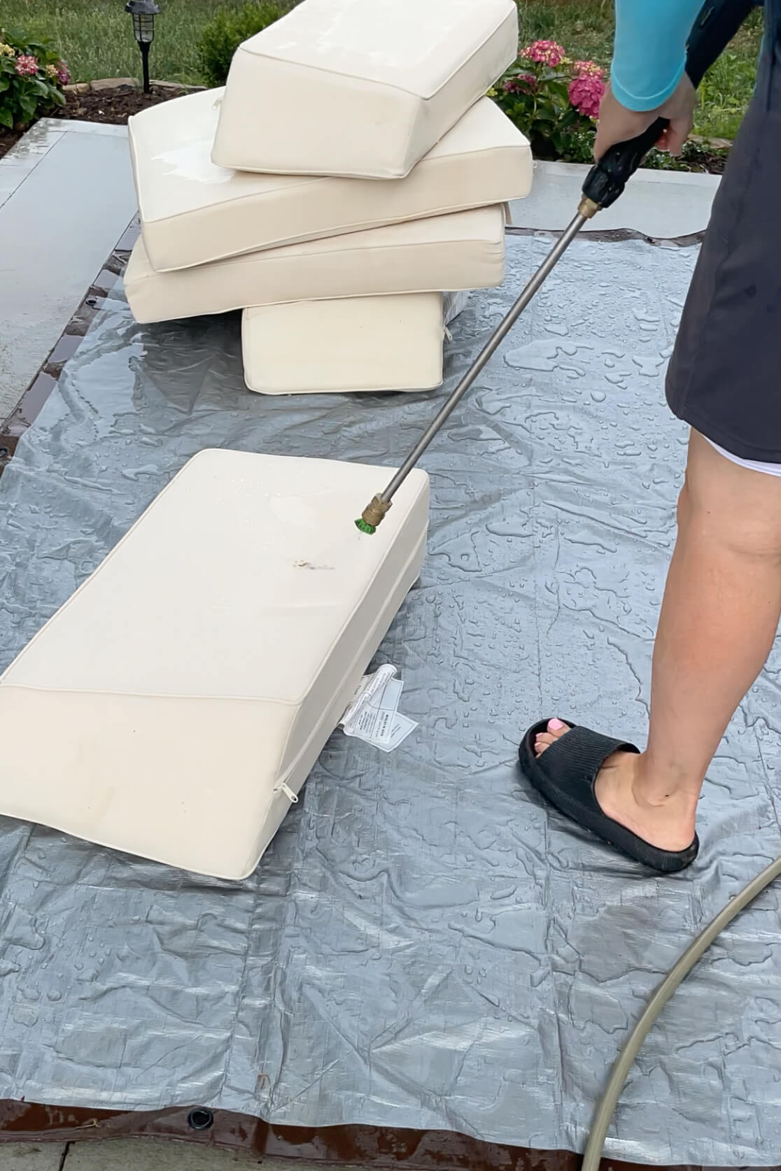 Using a pressure washer to clean patio furniture.